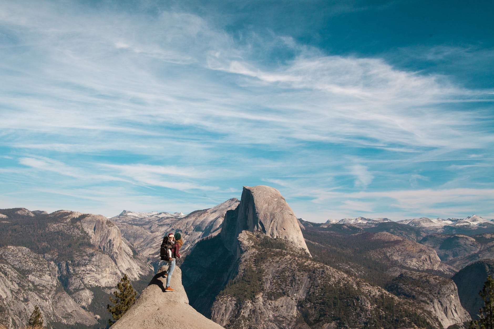 woman with baby at the peak of a mountain