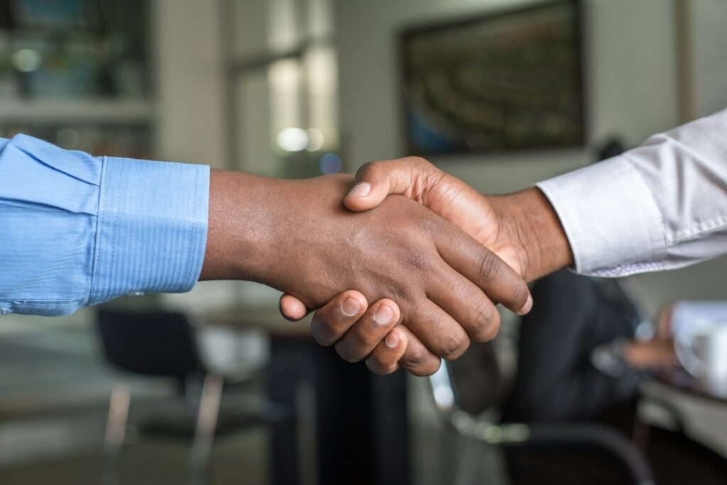 financial coach and client shaking hands